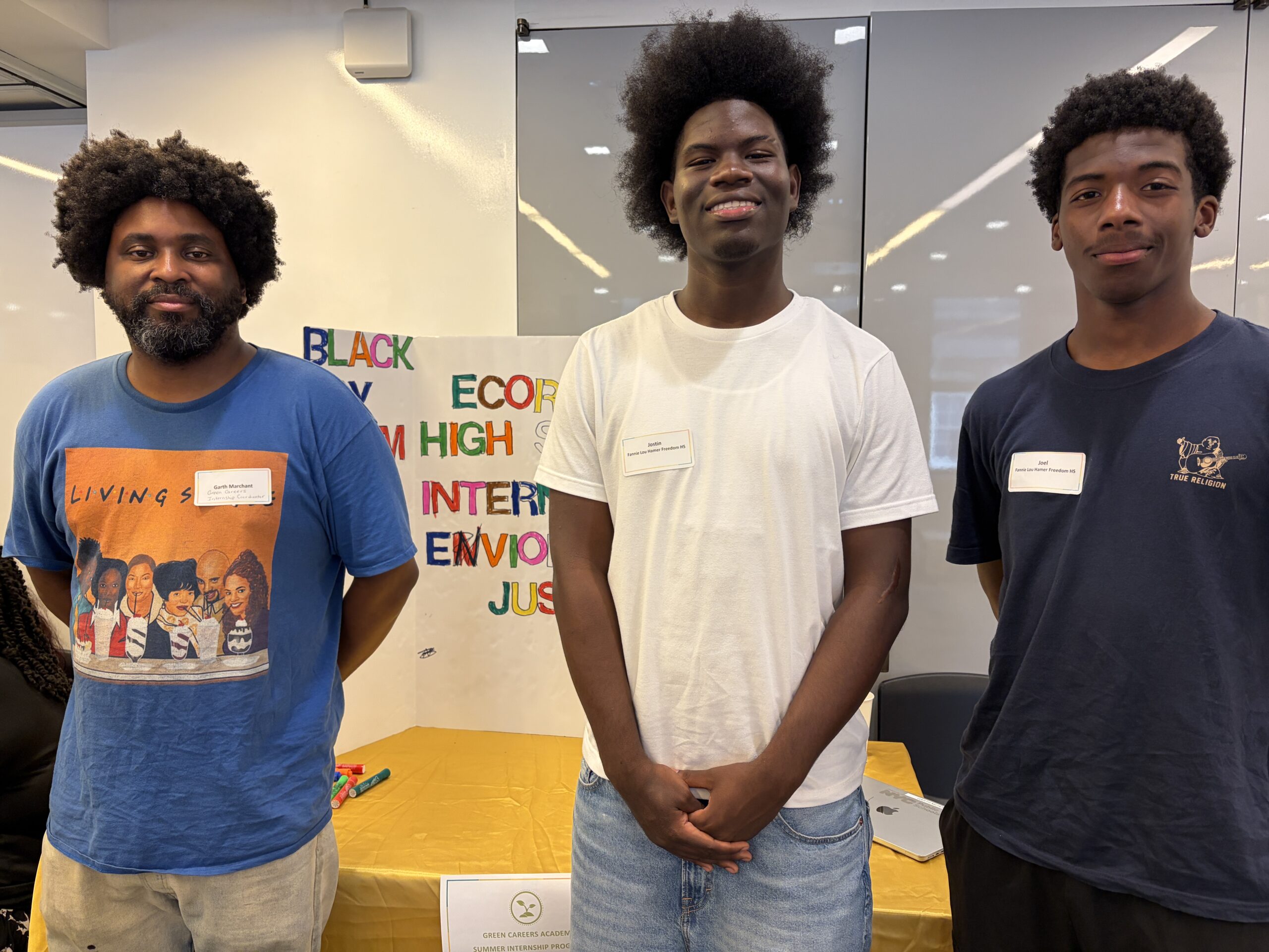 EcoRise Teacher Ambassador Garth Marchant standing with Green Careers Academy interns, Joel and Jostin in front of their poster at the NYC Student Innovation Showcase, May 2026.
